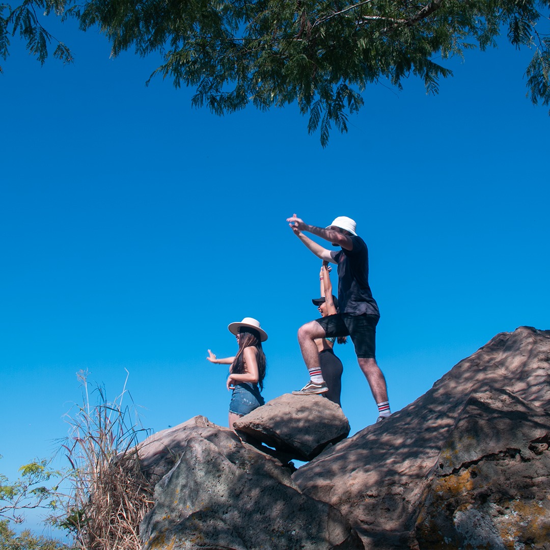 people on a top of a rock